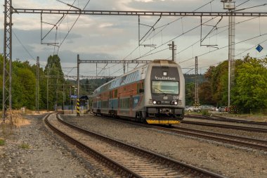 Trains in station with new platform near capital Prague in Ricany CZ 08 16 2024 clipart