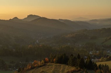 View for mountain deep valley in autumn color evening near Jaworki Poland 10 17 2024 clipart