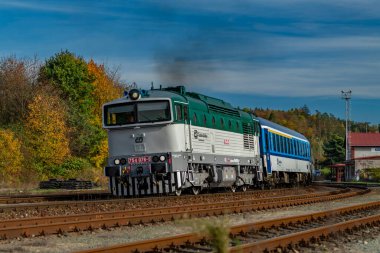 Trains in small east Bohemia station in sunny autumn afternoon in Starkoc CZ 10 19 2024 clipart