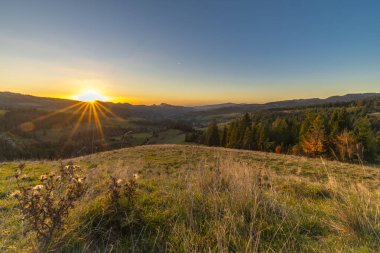 View for mountain deep valley in autumn color evening near Jaworki Poland clipart