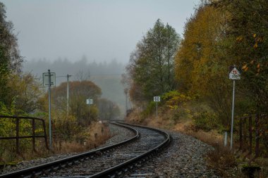 Foggy cold morning near small station close army area in Polna na Sumave CZ 10 27 2024 clipart