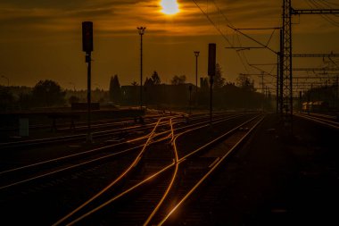 Renkli tren yolu ve demiryolu şalteri silueti ile gün batımı