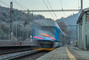 Trains with platform in frosty foggy autumn morning in station Hostejn CZ 11 10 2024 clipart