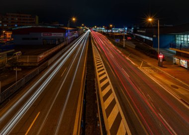 Ceske Budejovice CZ 11 12 2024 'te sonbahar bulutlu gecelerinde araba ışıkları caddelerde.