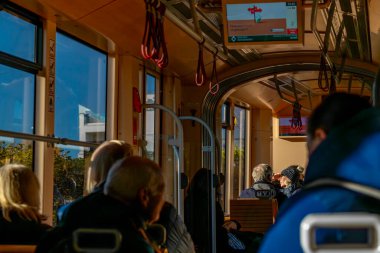 Interior of old historic tram with passengers in Linz Austria 11 25 2024 clipart