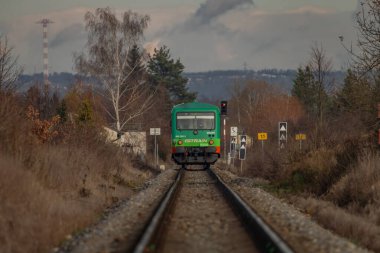 Diesel engine train unit green near city Budweis CZ 12 04 2024 clipart