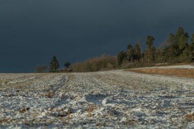 Sunrise with orange sun and winter snowy landscape near Nepomuk Bohemia town clipart