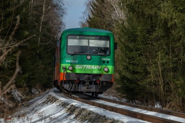 Privat green train engine unit in winter snowy day near Nova Pec CZ 01 23 2025 clipart