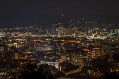 Kışın eski kuleyle tepeden bulutlu bir gece Graz Avusturya 'da soğuk bir akşam.