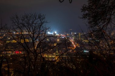 Kışın eski kuleyle tepeden bulutlu bir gece Graz Avusturya 'da soğuk bir akşam.