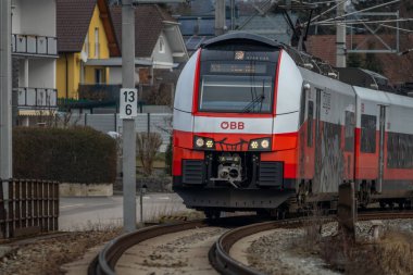 Electric unit passenger train in cloudy winter day near St.Georgen Gusen Austria 02 02 2025 clipart