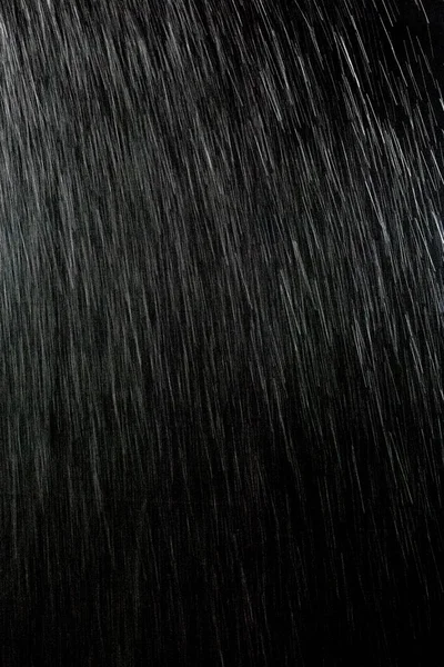 黒い背景に雨します — ストック写真