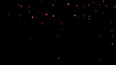 S büyüklüğünde parlak kırmızı parçacıkların döküldüğü bir video.