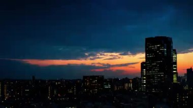 Video of sky, clouds, city and buildings, night view from sunset