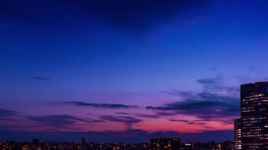 Video of sky, clouds, city and buildings, night view from sunset