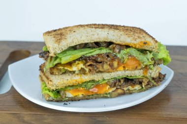 Sandviç 'i kesme tahtasına yakın çekim yap. İştah açıcı sığır eti parçaları..