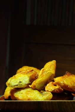 Pisang Goreng veya Endonezya 'dan gelen muzlu börekler ahşap tabakta servis edilir. Stüdyo çekimi