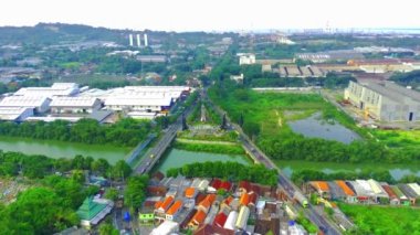 Aerial shot of Border between Surabaya and Gresik with the traffic crossing the bridge over the Lamong river and the industrial estates.