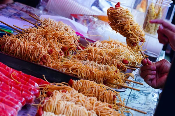 Street foods displays around Sam Poo Kong Temple. Semarang. Indonesia. In Chinese New Year 2023. Street Photography.