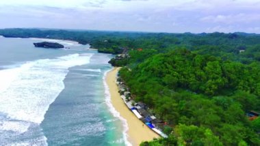 Plajda beyaz kumlar ve kayalar olan Sundak Sahili, Yogyakarta, Endonezya.
