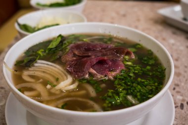 Close up of Vietnamese pho soup with beef, meatball, fresh vegetable. Food Photography.