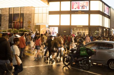 March 2, 2023. Bukit Bintang, Kuala Lumpur. People crossing the street at night when raining. Street Photography.