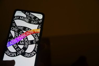 Kurulumdan sonra açılmak üzere Instagram 'ın İplik Uygulamasını gösteren bir smatphone tutan bir el. Teknoloji fotoğrafçılığı.