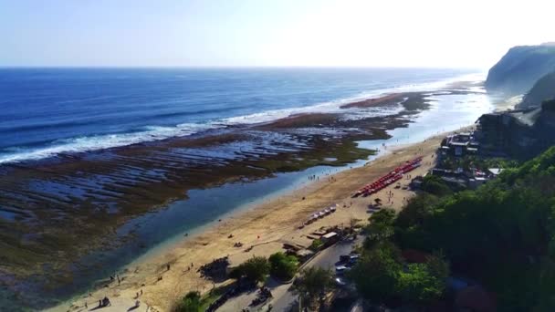 印度尼西亚巴厘Melasti海滩 用无人驾驶飞机从空中拍摄 展示广阔的海洋景观和广阔的沙滩 以及沿着海岸线进行的活动 空中图像 — 图库视频影像