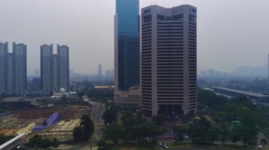 Jakarta, Endonezya 'daki Jalan Jenderal Sudirman' ın şehir manzarası. Uzun gökdelenler işlek caddede, arabalar ve insanlar aşağıda hareket ediyor. Hava görüntüleri