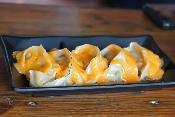 stock image Pan-fried gyoza dumplings with golden brown wrappers, filled with savory meat or vegetable goodness.