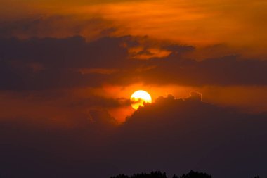 Soluk kesen bir günbatımı, Endonezya 'nın sakin sularını yansıtan ve uzun gölgeler oluşturan sakin Surabaya sulak arazisinin üzerinde ateşli turuncu renklerle gökyüzünü boyar..