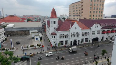 January 4, 2025. Aerial view of a bustling street in Surabaya, Indonesia showcasing an old town mix of traditional and modern architecture, with a prominent row of buildings. clipart