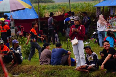 February 2, 2025. Probolinggo, Indonesia. Enthusiastic spectators were watching the Karapan Sapi Brujul or Bull Race under a slightly cloudy sky. clipart