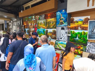 January 29, 2025. Bandung, Indonesia. A lively scene on Jalan Braga, bustling with traffic and pedestrians, featuring a colorful tour bus amidst the festive atmosphere of Chinese New Year celebrations clipart