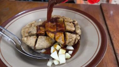 Lezzetli bir tabak pempek, lezzetli bir Endonezya balık keki servis ediliyor. Pempek, Cuko adı verilen ve doğranmış salatalıkla kaplıdır..