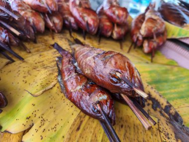 Muz yaprağında tütsülenmiş balık şişleri, Endonezya, Surabaya 'da popüler bir sokak yemeği lezzeti. Altın sarısı ve iştah açıcı.