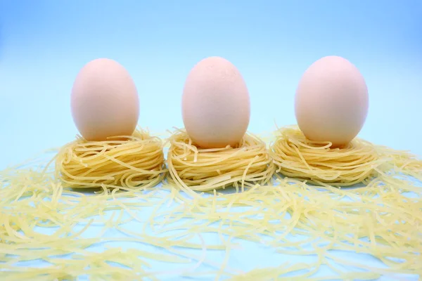 Funny Easter Eggs Composition with Nest Pasta