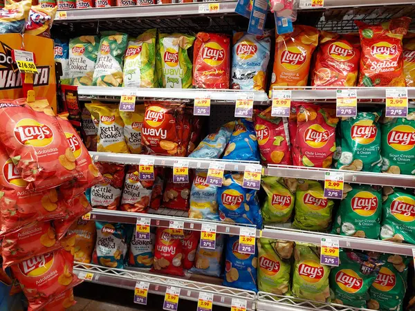 stock image Los Angeles, California - July 21, 2024: bags of different flavors of LAY'S on a shelf in a supermarket