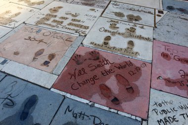 Hollywood, Los Angeles, California - July 22, 2024: TLC Grauman's Chinese Theatre Handprints Footprints and signatures cemented in the forecourt of the theater clipart