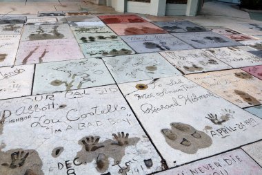 Hollywood, Los Angeles, California - July 22, 2024: TLC Grauman's Chinese Theatre Handprints Footprints and signatures cemented in the forecourt of the theater clipart