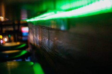 blurred background of a wooden table with a glass of wine