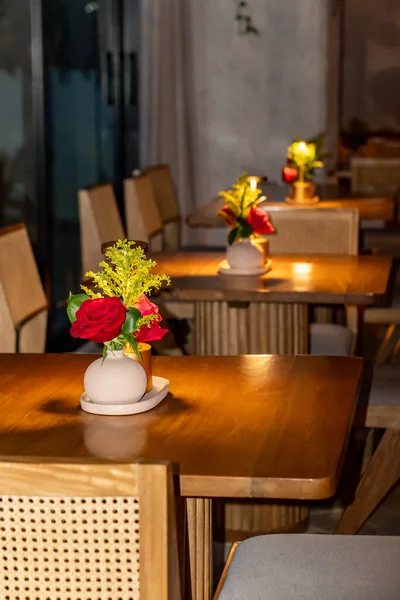 beautiful luxury flower vase with flowers on table in cafe