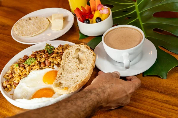 stock image Colombian breakfast with arepas, coffee, bread, eggs, warmed rice and fruit