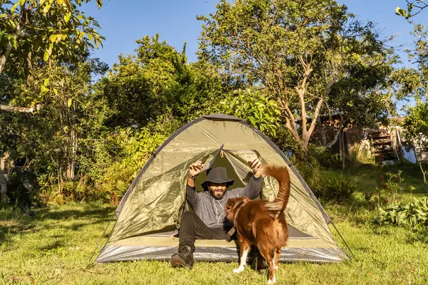adventurous man camping with his dog