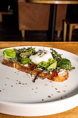 Fransız tostu, salata ve haşlanmış yumurta, gurme otel restoranı. Tahta masa..