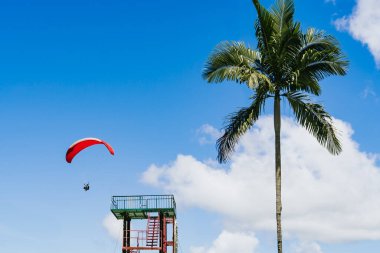 View of the sky. Person flying in a paraglider, leisure activity. Travel and landscapes. clipart