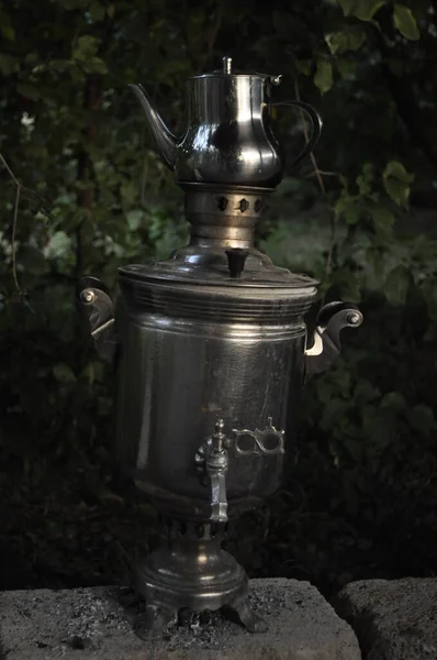 Vintage samovar in the garden at night, Russia.