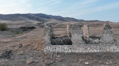 a destroyed old house in the mountainous terrain