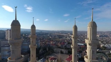 The aerial view of an Islamic mosque with four magnificent minarets