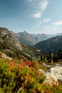 Beautiful mountainscape at Maple Pass Hike with lush autumn colors of wild blueberries in the Cascades Mountain Range of North Cascades National Park in Washington USA near the Canadian Border. clipart